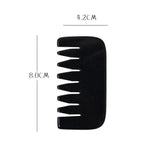 a black plastic comb with a white background