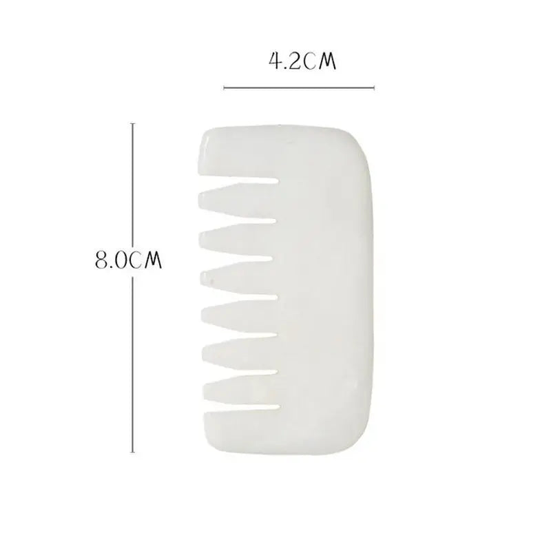 a white plastic comb with a white handle