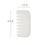 a white plastic comb with a white handle