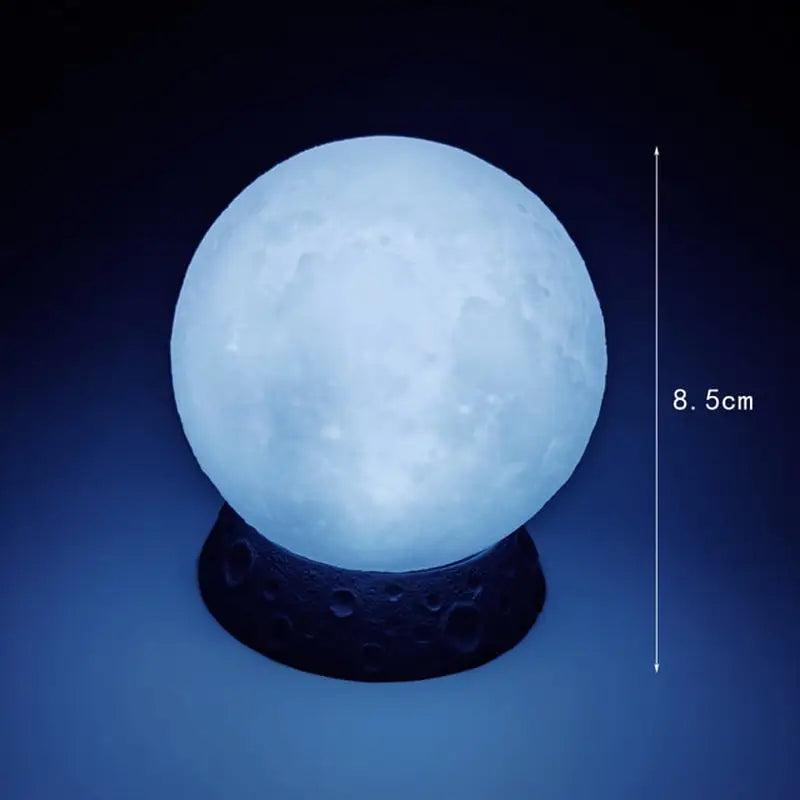 the moon lamp is lit up in the dark