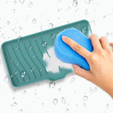 someone is cleaning a tray with a sponge and a blue sponge