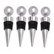 three silver wine stoppers with black tops and silver balls