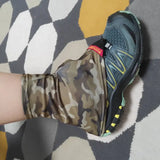 a person wearing camouflage shoes