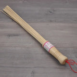 a wooden stick with a red string on it