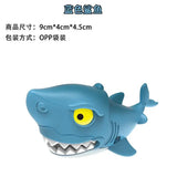 a toy shark with a yellow eye and a white background