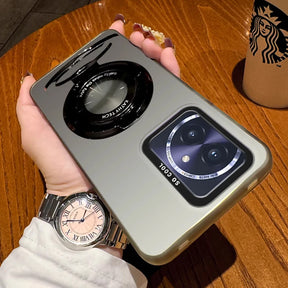 Silver smartphone case with a circular camera lens design and a rectangular camera module.