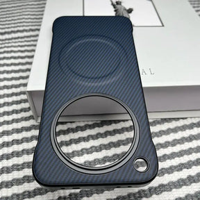 Dark blue carbon fiber phone case with a large circular camera cutout and a smaller circular cutout.