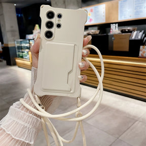 A white phone case with a built-in card holder and an attached lanyard.