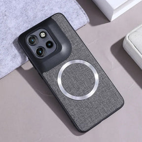 A dark grey fabric phone case with a black camera module and a silver magnetic ring.