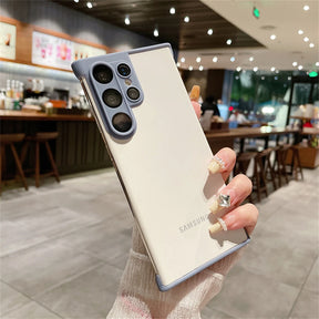 White smartphone with a light purple camera module and trim, held by a hand with decorated nails.