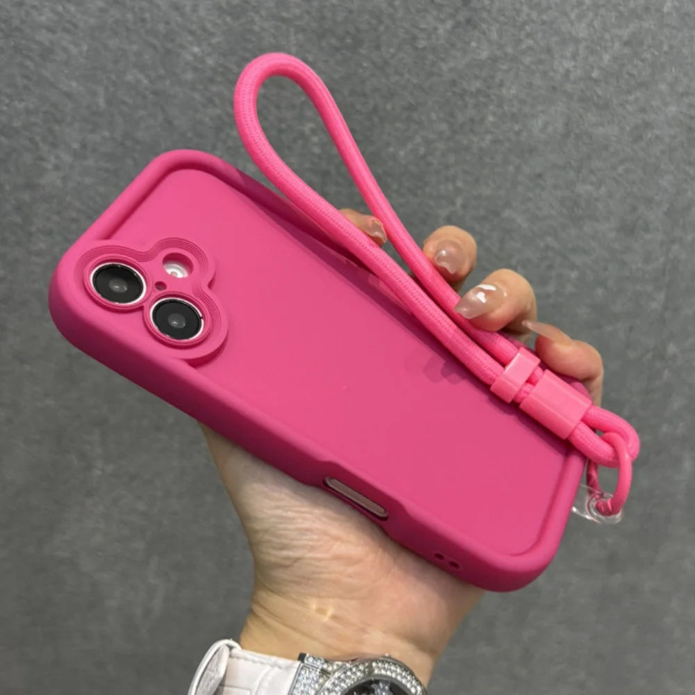 Hot pink silicone phone case with a matching wrist strap.