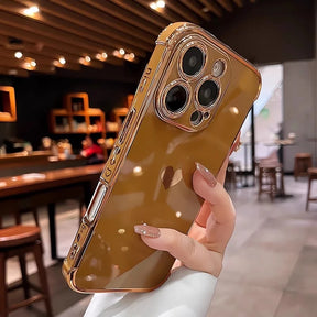 Brown phone case with a heart cutout and gold trim