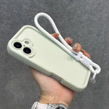 Light green smartphone case with a white wrist strap.