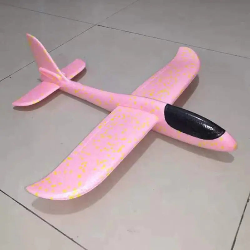 a pink toy plane sitting on the floor