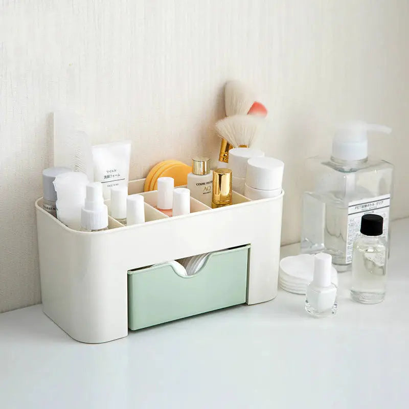 a white bathroom organizer with a green drawer