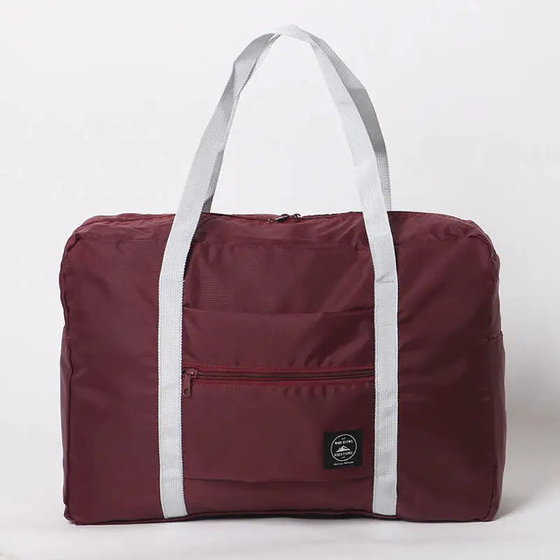 a maroon duff bag with a white stripe around the bottom