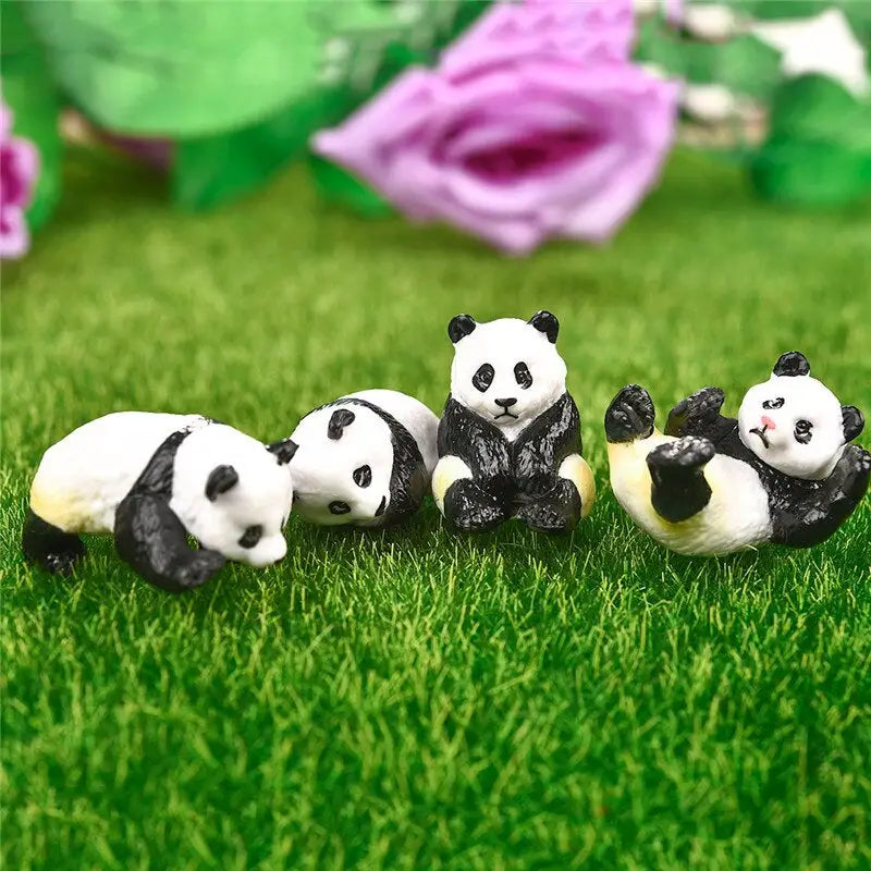 three panda bears sitting on the grass