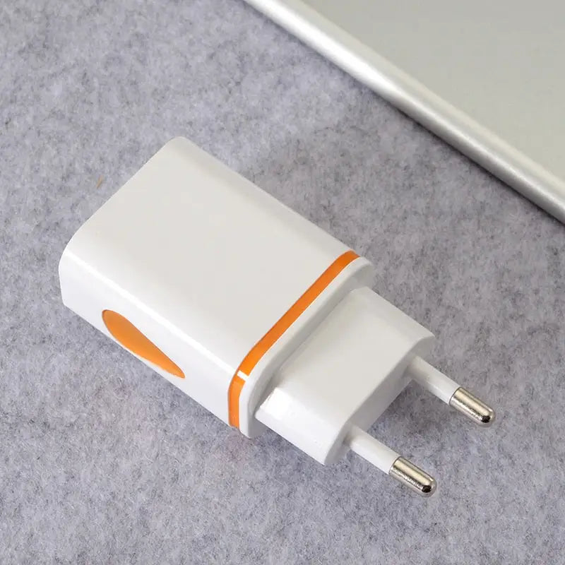 an orange and white usb charger on a gray surface