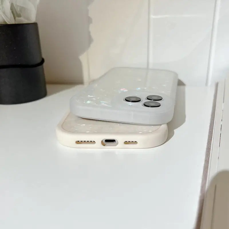a white phone sitting on top of a white table