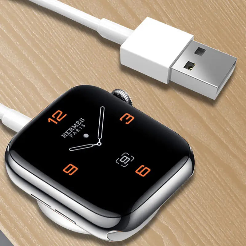 an apple watch with a charging cable attached to it