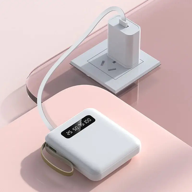 an apple watch charging station on a pink background