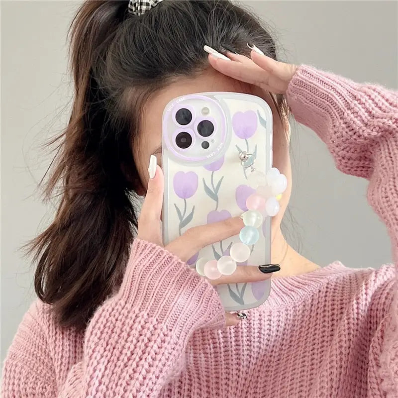 araffe girl taking a selfie with her phone while wearing a pink sweater