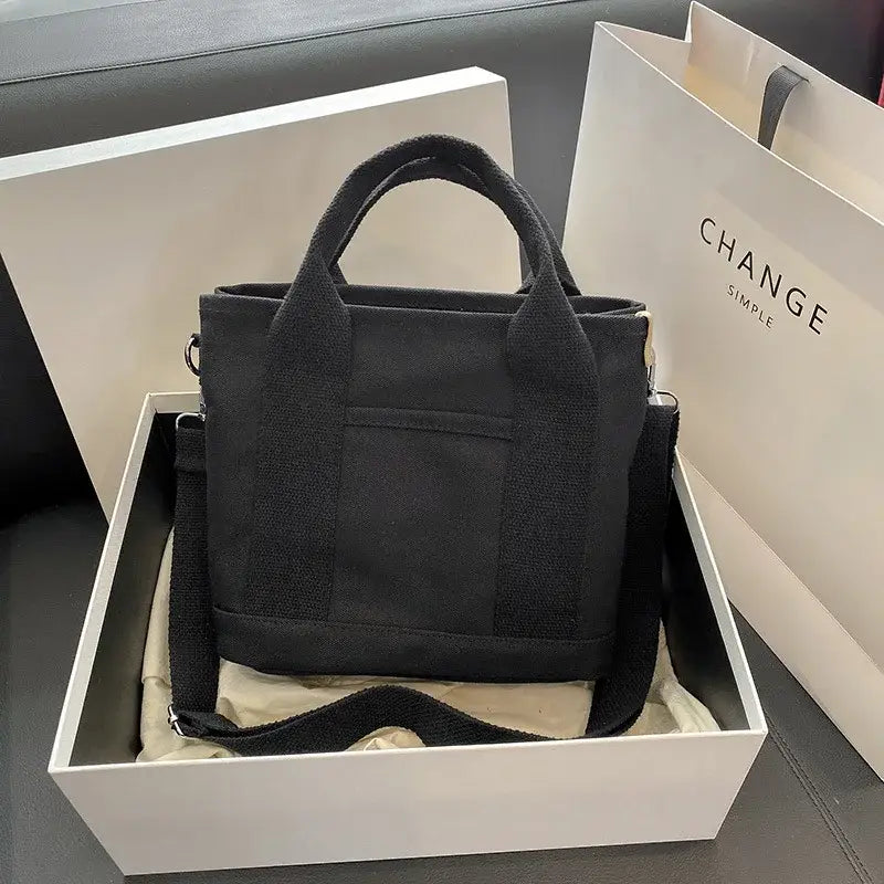 araffe black bag in a box with a white bag in the background