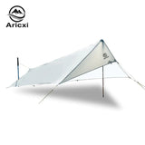 a white tent with a tarp attached to it