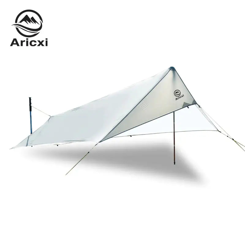 a white tent with a tarp attached to it