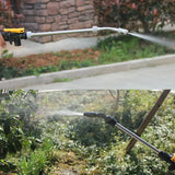 a man using a hose to water a garden
