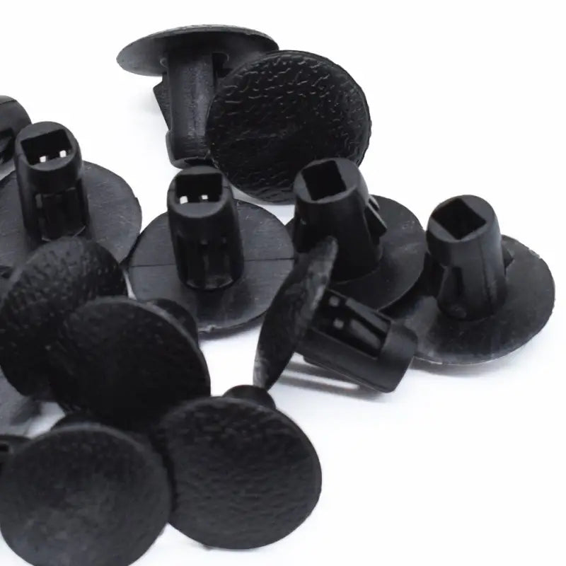 a pile of black plastic screws