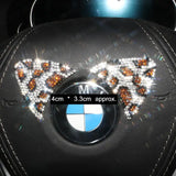 a close up of a bmw emblem with some diamonds on it