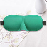 a green eye mask with a black strap