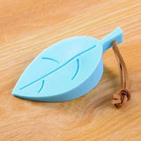 a blue leaf shaped object on a wooden table