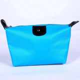 a blue cosmetic bag with black handles