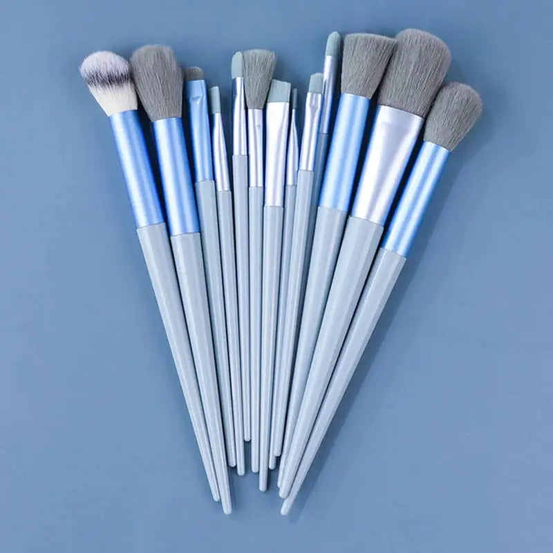 a set of makeup brushes on a blue background
