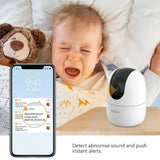 a baby is laying in bed next to a baby monitor