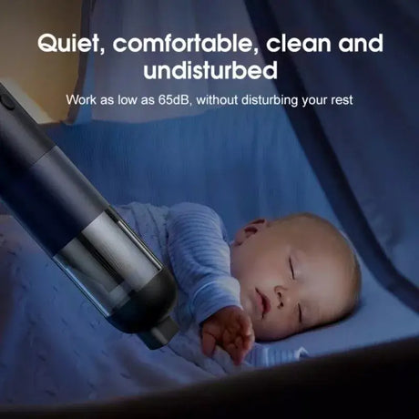 A baby laying in a bed with a vacuum