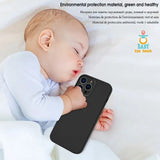 a baby laying on a bed with a phone case