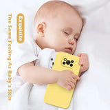 A baby sleeping on a white bed with a yellow phone case