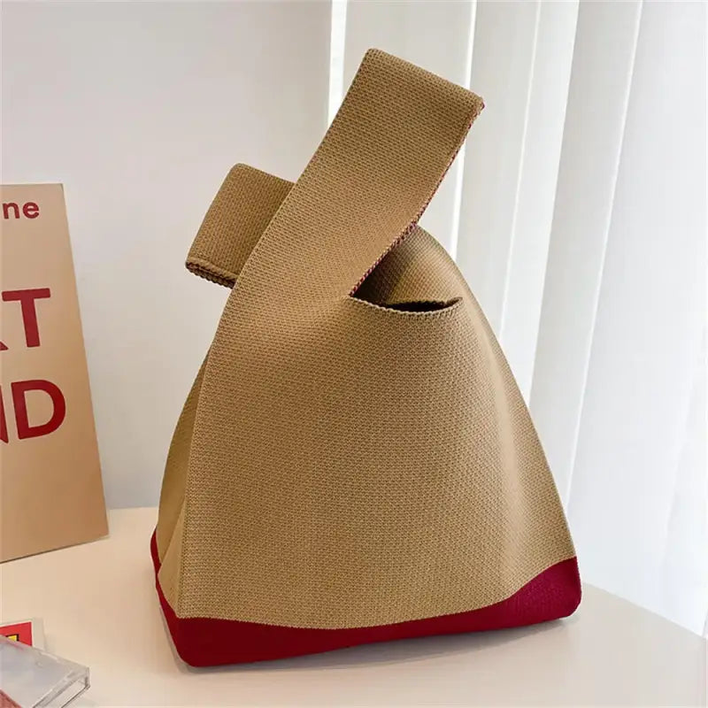 a bag with a red handle on top of it