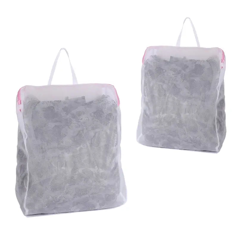 two bags of bags with handles are sitting on a white surface