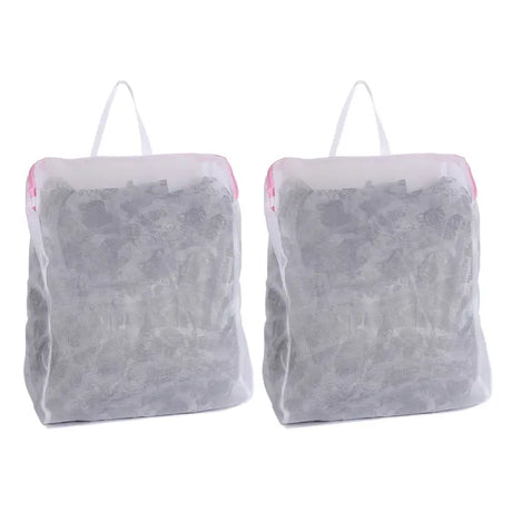 two bags of clothes are sitting on a white surface