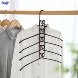 a white shirt hanging on a wooden hanger