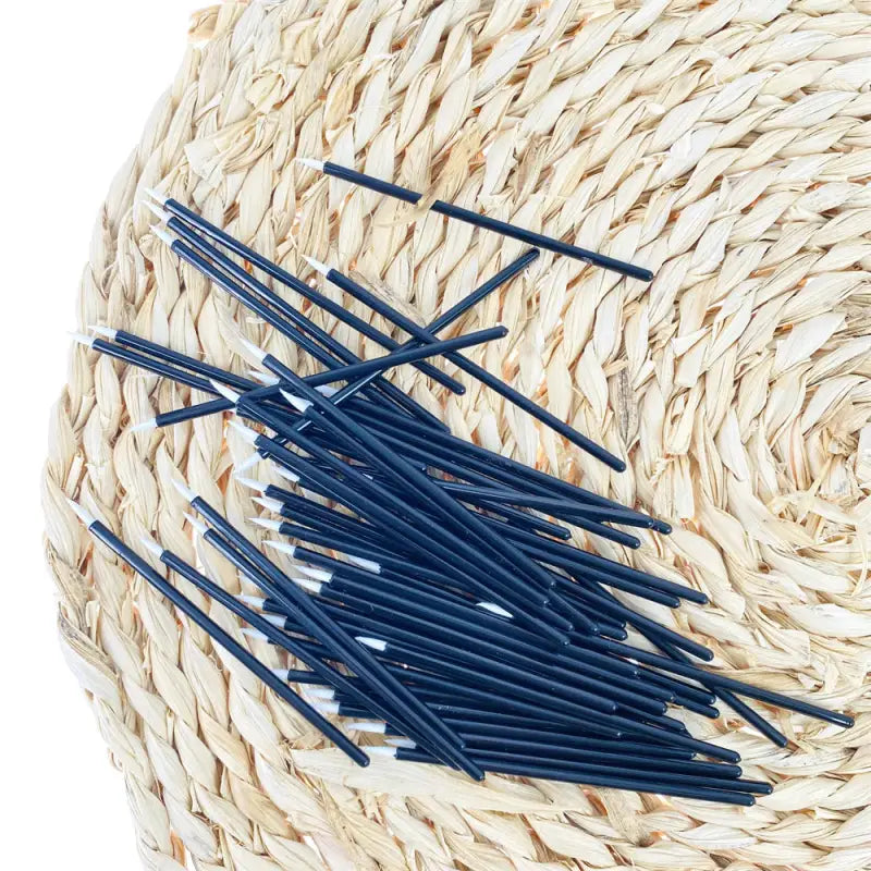 a basket with straw straws and blue pins