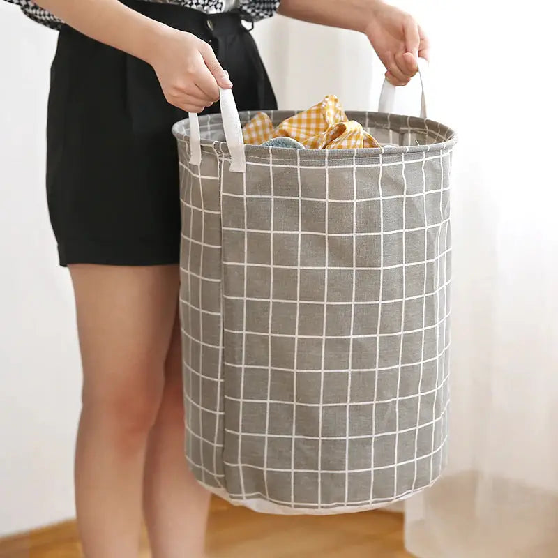 a woman holding a gray and white plaid fabric bag