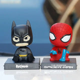 batman and spider - man figurines on display on a table