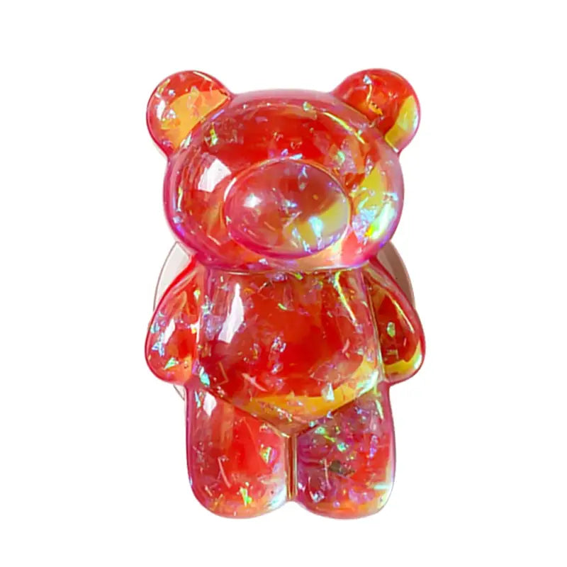 there is a glass bear that is sitting on a white surface