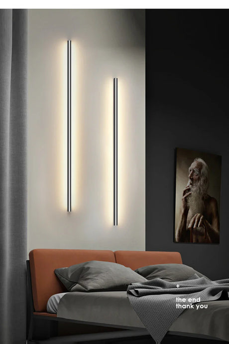 a bed with a light on the wall