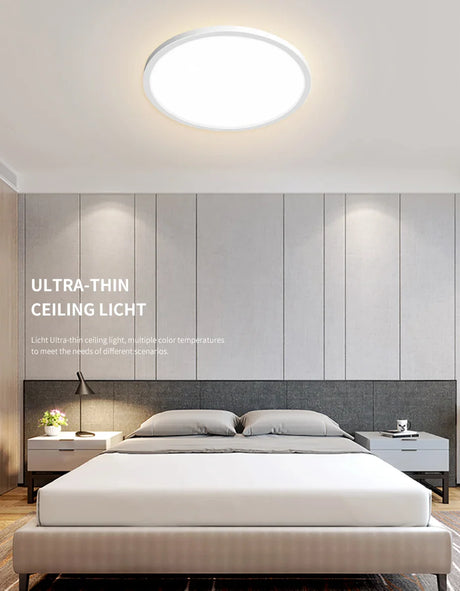 a bedroom with a bed and a wall mounted light